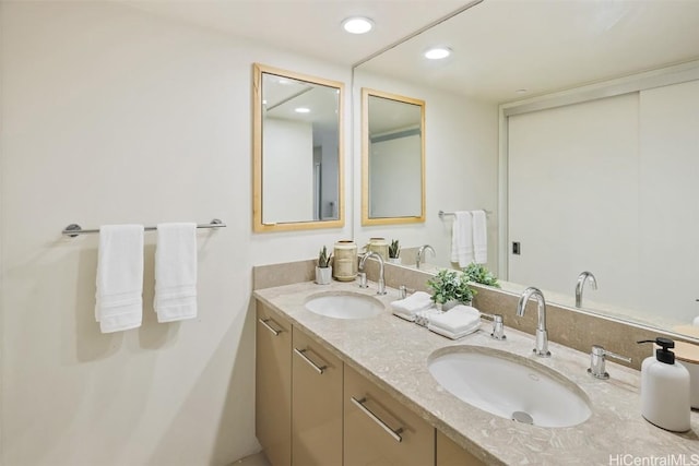 full bathroom featuring double vanity, a sink, and recessed lighting