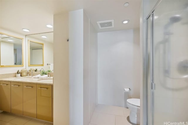 bathroom with double vanity, visible vents, tile patterned flooring, a shower stall, and a sink