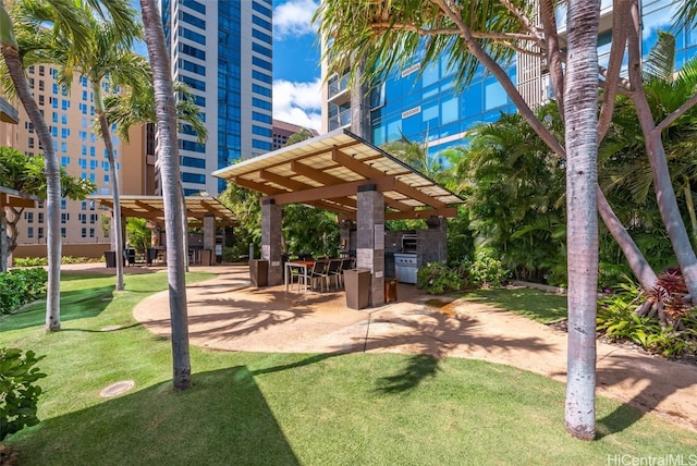 surrounding community featuring a yard and a pergola