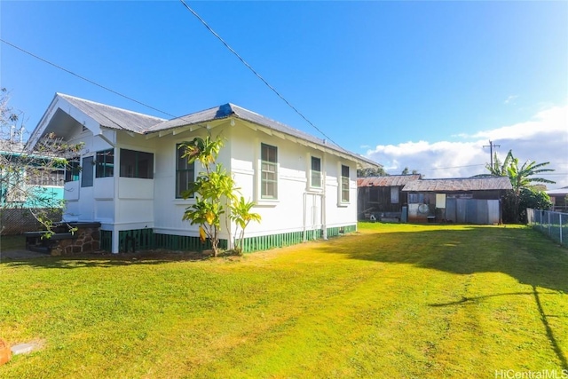 exterior space with a yard and fence