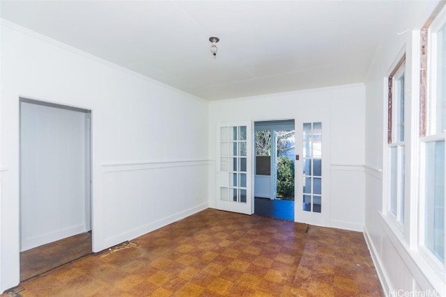 spare room featuring crown molding and french doors