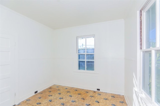 empty room featuring baseboards and ornamental molding