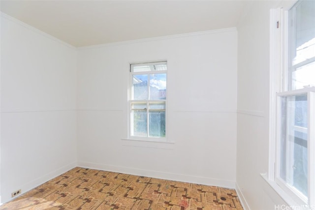 spare room featuring ornamental molding and baseboards