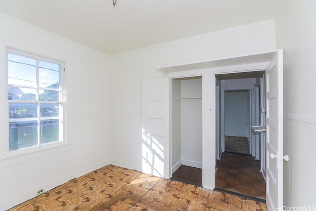 unfurnished bedroom with baseboards and ornamental molding