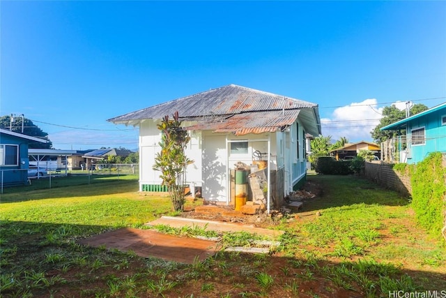 view of outdoor structure with fence and an outbuilding