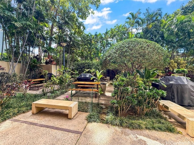 view of property's community with a patio area and fence