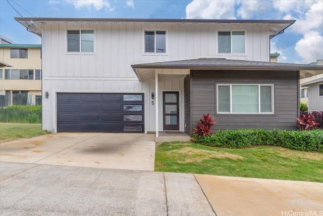 view of front of house with board and batten siding, a front yard, driveway, and an attached garage