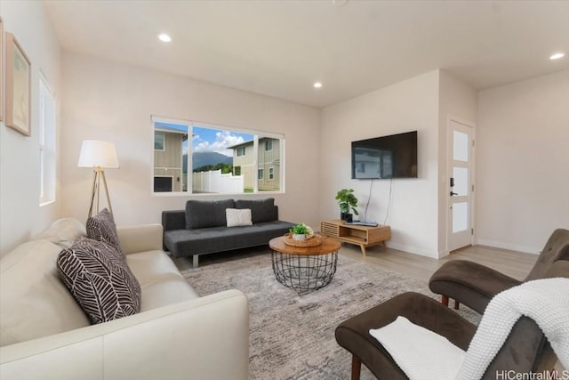 living room with baseboards, wood finished floors, and recessed lighting