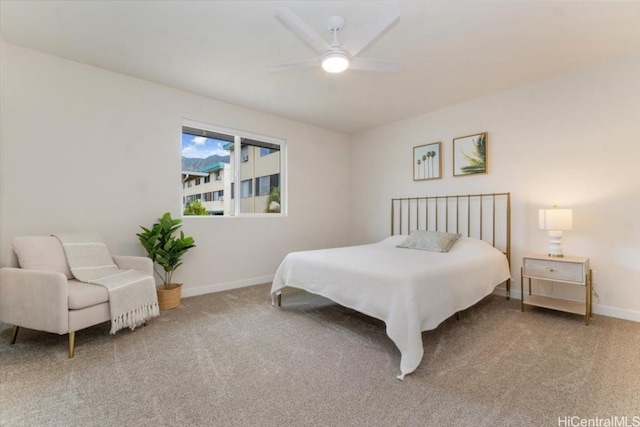 bedroom with ceiling fan, carpet flooring, and baseboards