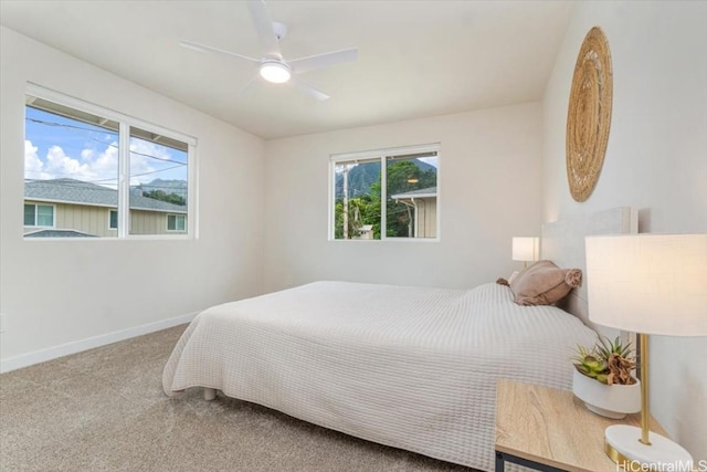 carpeted bedroom featuring a ceiling fan and baseboards