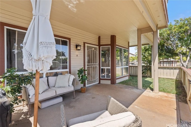 view of patio featuring an outdoor living space and fence