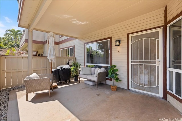 view of patio / terrace featuring an outdoor living space, a grill, and fence