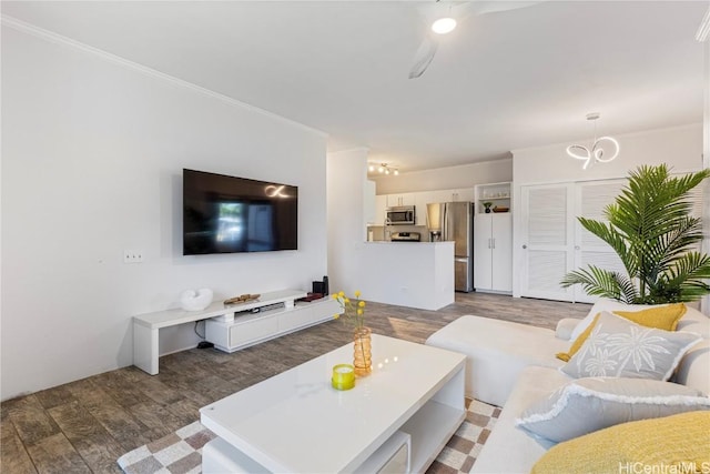 living area featuring dark wood-style floors and ornamental molding