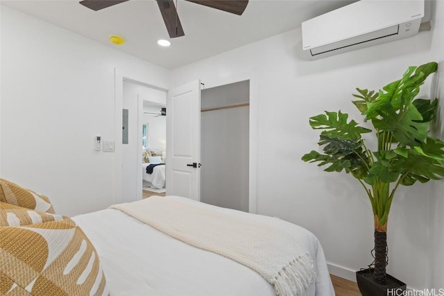 bedroom with recessed lighting, a closet, a wall mounted AC, ceiling fan, and wood finished floors