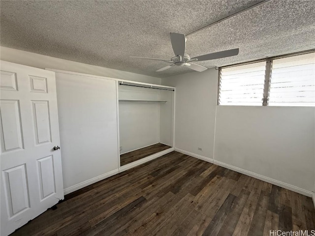 unfurnished bedroom with a textured ceiling, ceiling fan, wood finished floors, baseboards, and a closet