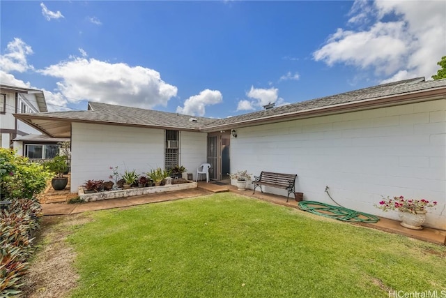 rear view of property featuring a yard