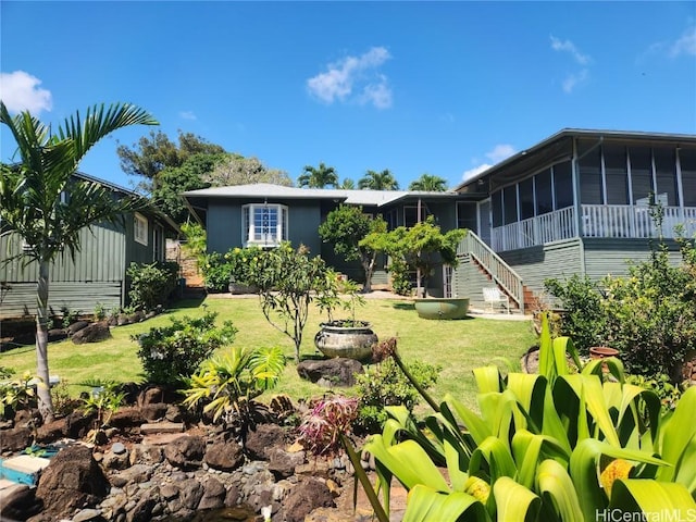 view of yard with a sunroom and stairway