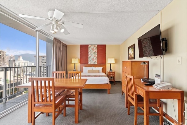 carpeted bedroom featuring a view of city, floor to ceiling windows, and a textured ceiling