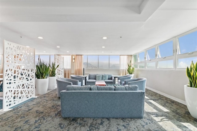 carpeted living room with recessed lighting and baseboards