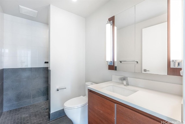 bathroom with toilet, walk in shower, and vanity