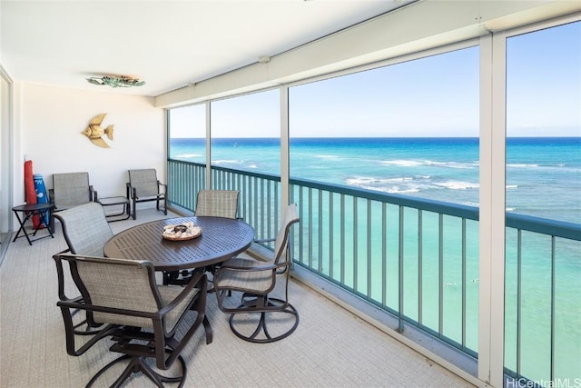 sunroom / solarium featuring a water view