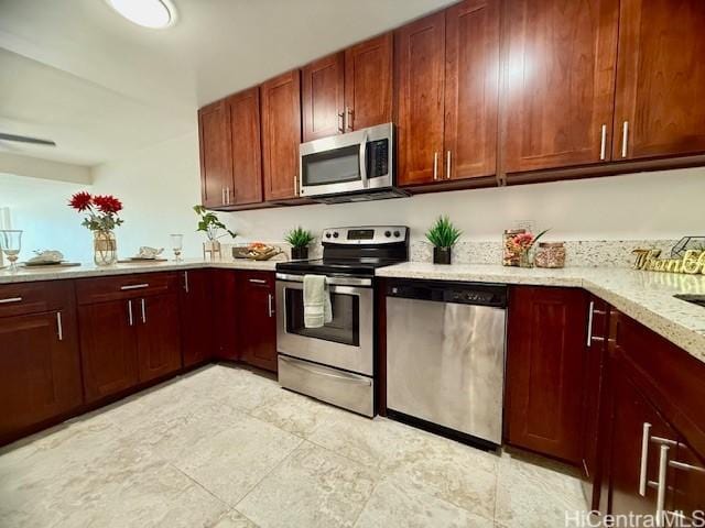 kitchen with light stone countertops and stainless steel appliances