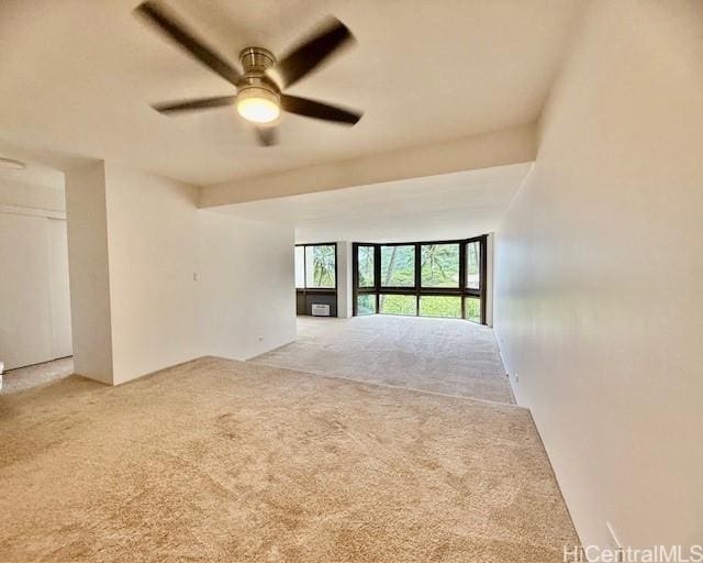 unfurnished room with ceiling fan and carpet flooring