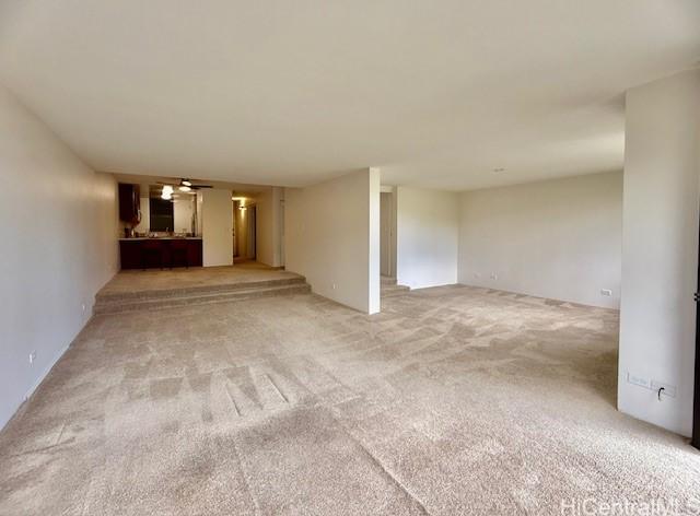 unfurnished living room with light colored carpet