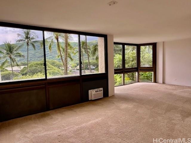 unfurnished sunroom with a wall unit AC, a healthy amount of sunlight, and a water view