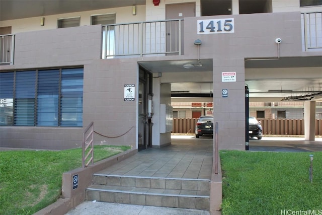 view of exterior entry featuring concrete block siding