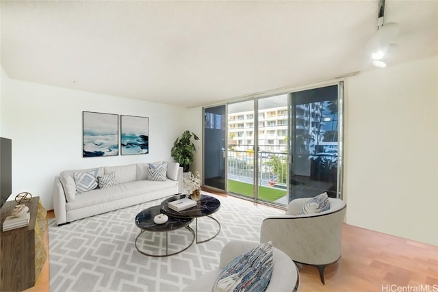 living room with wood finished floors and expansive windows