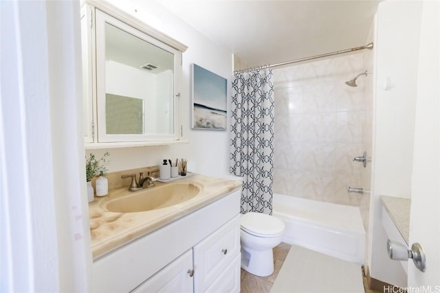 bathroom with vanity, toilet, and visible vents