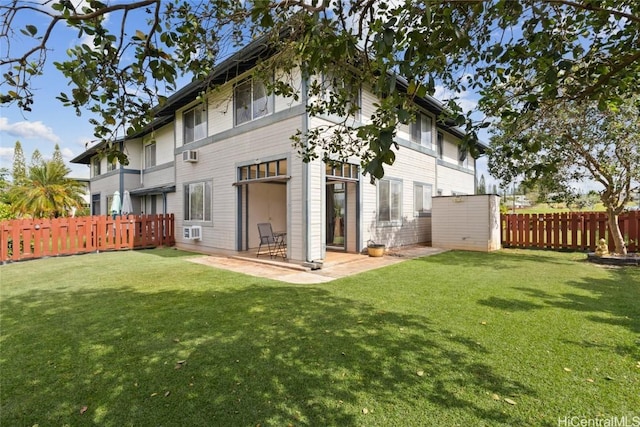 rear view of property featuring a yard, fence, and a patio