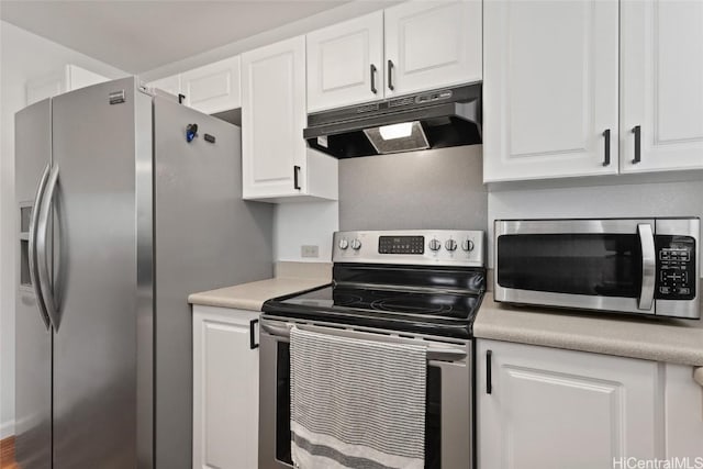 kitchen with under cabinet range hood, white cabinetry, appliances with stainless steel finishes, and light countertops