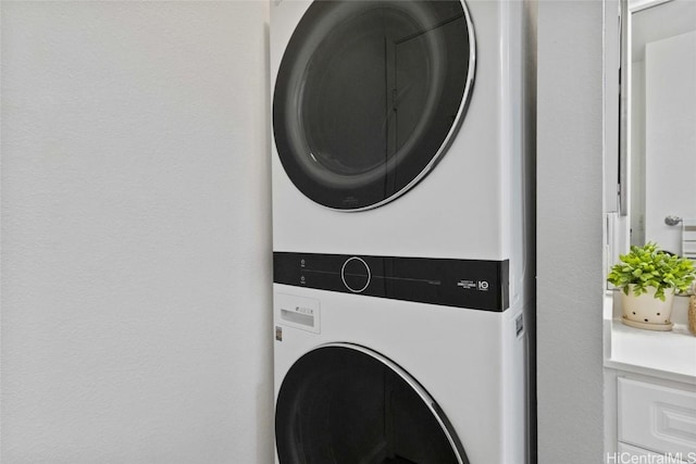 laundry area with laundry area and stacked washer and clothes dryer