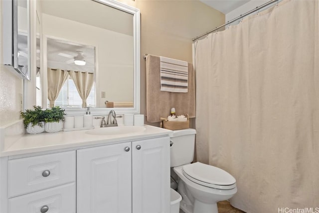 bathroom with ceiling fan, vanity, and toilet