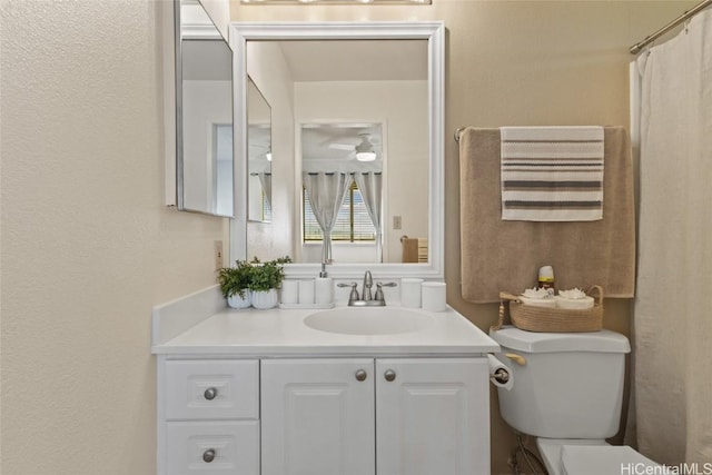 bathroom with toilet and vanity