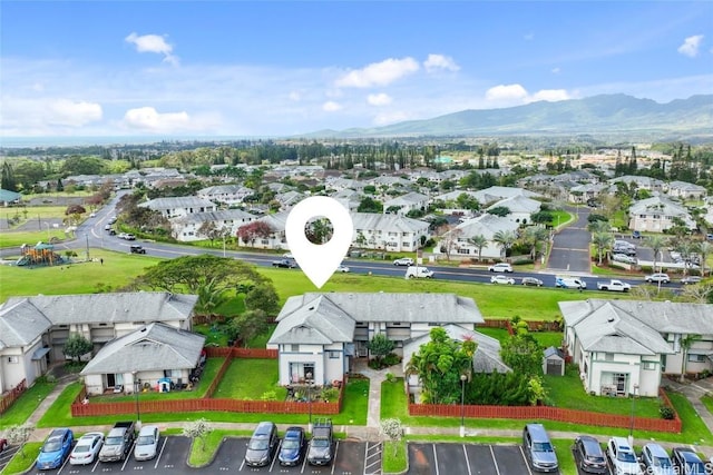 drone / aerial view featuring a residential view and a mountain view