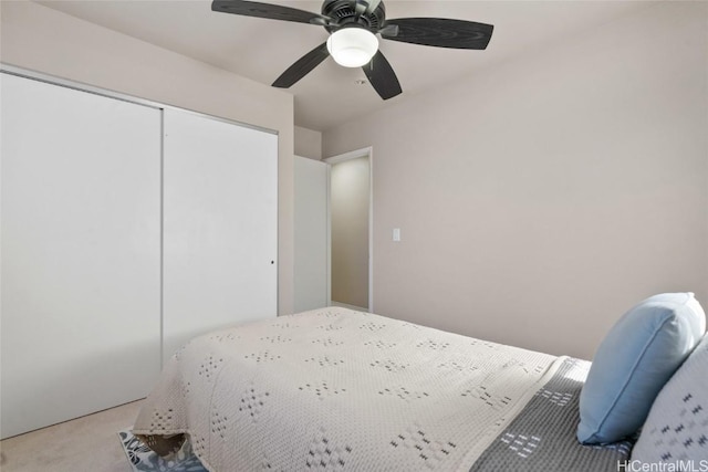 unfurnished bedroom featuring a closet, light carpet, and ceiling fan