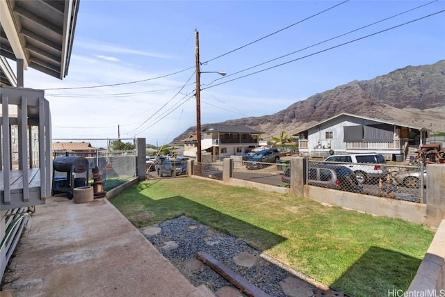 view of yard with fence private yard and a mountain view