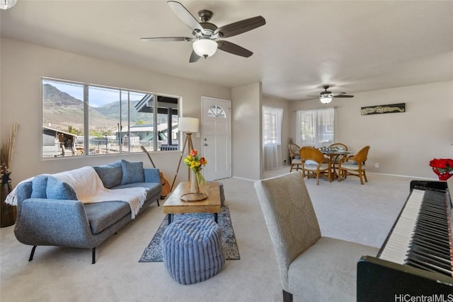 living area with a mountain view, carpet floors, and a wealth of natural light