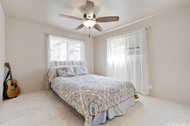 bedroom with a ceiling fan and carpet flooring