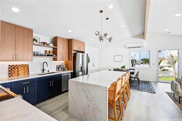 kitchen with light wood-style flooring, stainless steel appliances, an AC wall unit, open shelves, and a sink