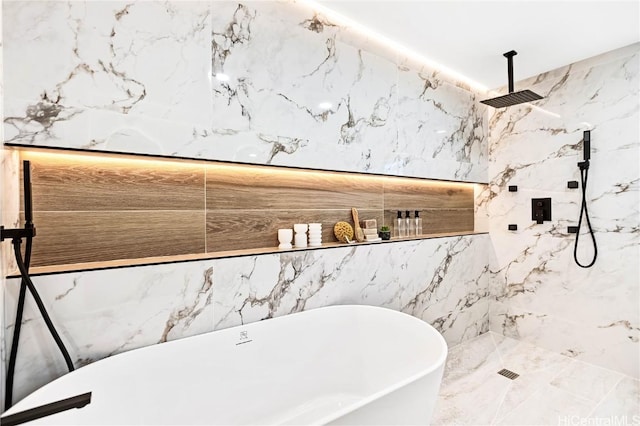 full bathroom featuring a soaking tub and a marble finish shower