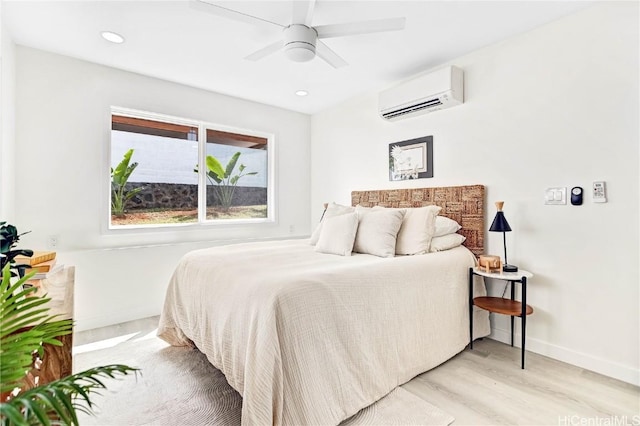 bedroom featuring a wall mounted AC, baseboards, ceiling fan, light wood-style floors, and recessed lighting