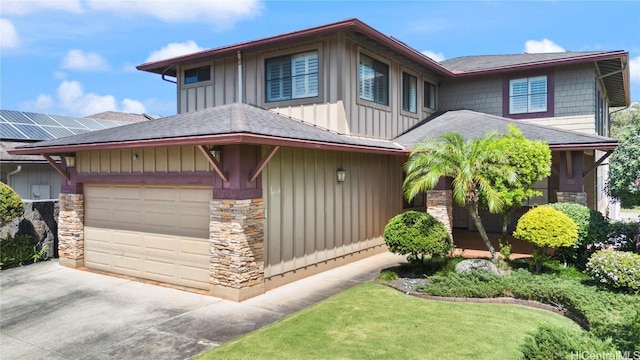 view of front of property with a garage, a shingled roof, concrete driveway, stone siding, and board and batten siding