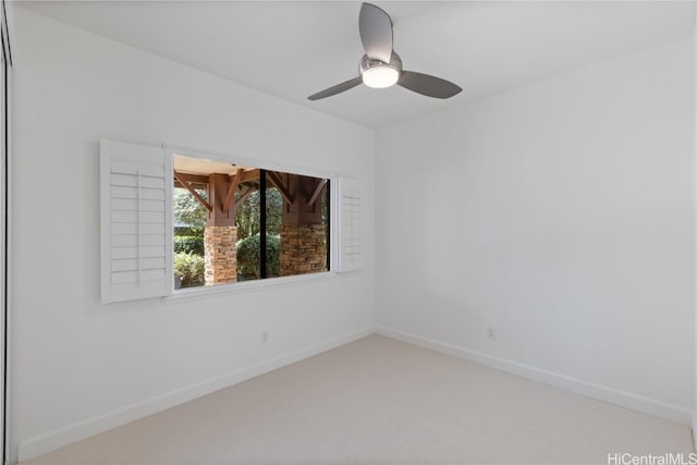 unfurnished room featuring carpet floors, baseboards, and a ceiling fan