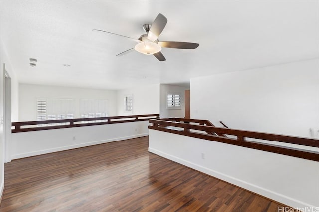 spare room featuring wood finished floors and baseboards