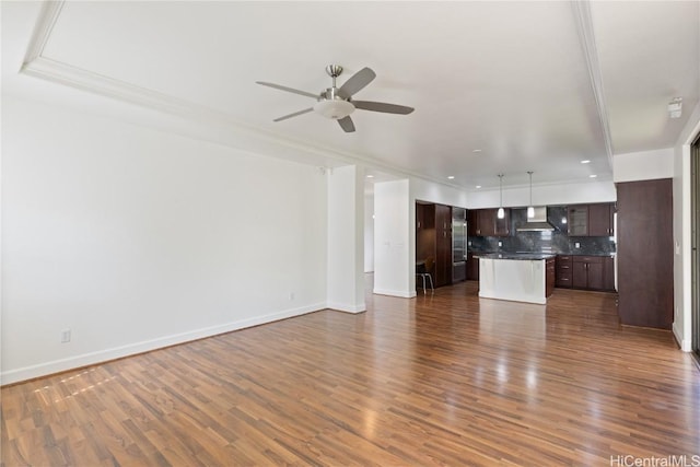 unfurnished living room featuring ceiling fan, dark wood-type flooring, and baseboards