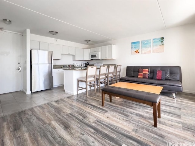 living area featuring wood finished floors and baseboards